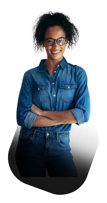 Mulher sorridente vestindo camisa jeans e óculos, com braços cruzados, simbolizando confiança e profissionalismo.